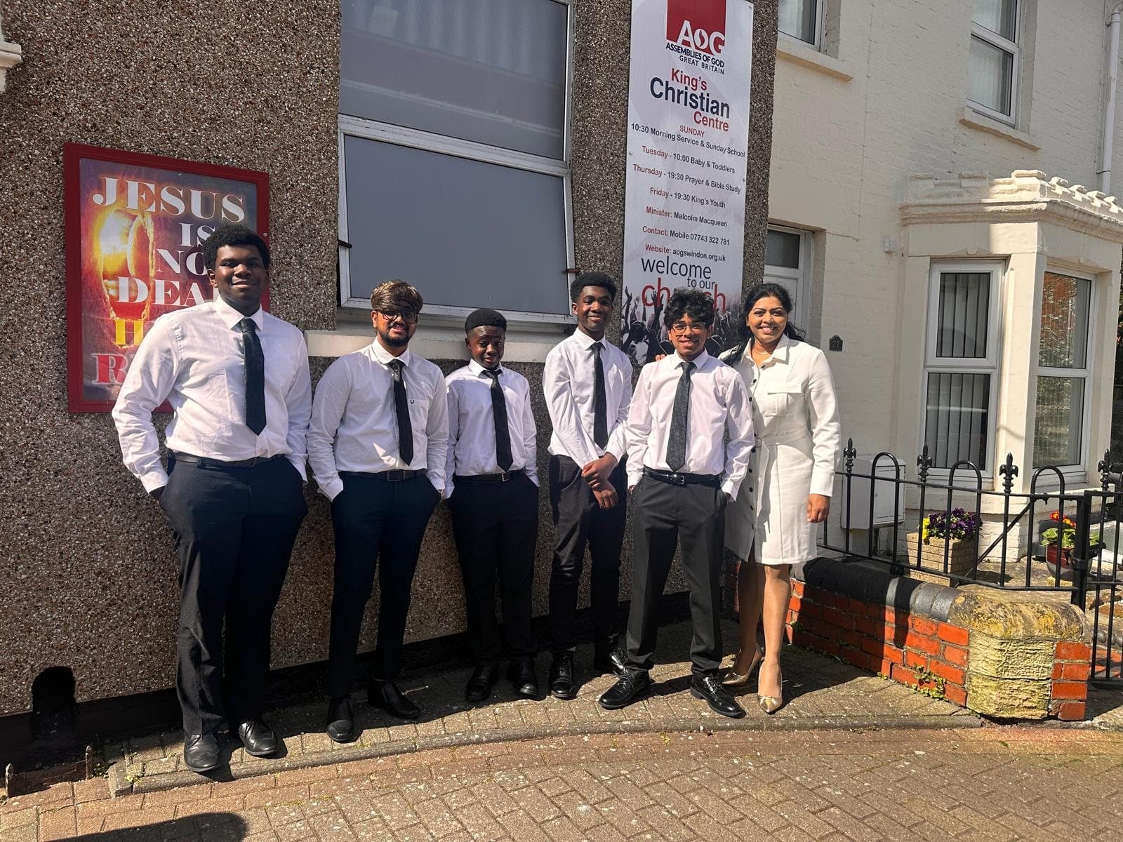Young people from King's Youth standing outside King's Christian Centre in white shirts and ties