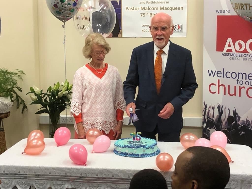 Pastor Malcolm and Sister Marion cutting the cake at his 75th birthday celebration in the church