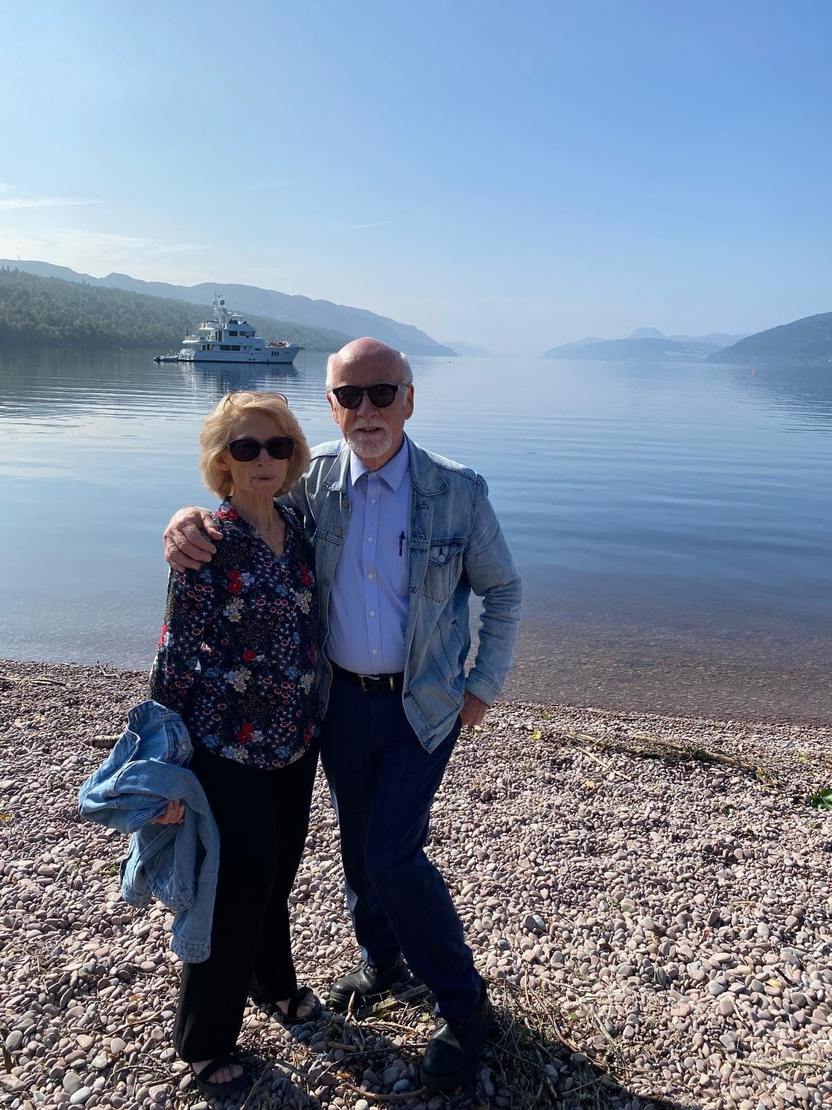 Pastor Malcolm Macqueen and Sister Marion standing together beside a lake on holiday