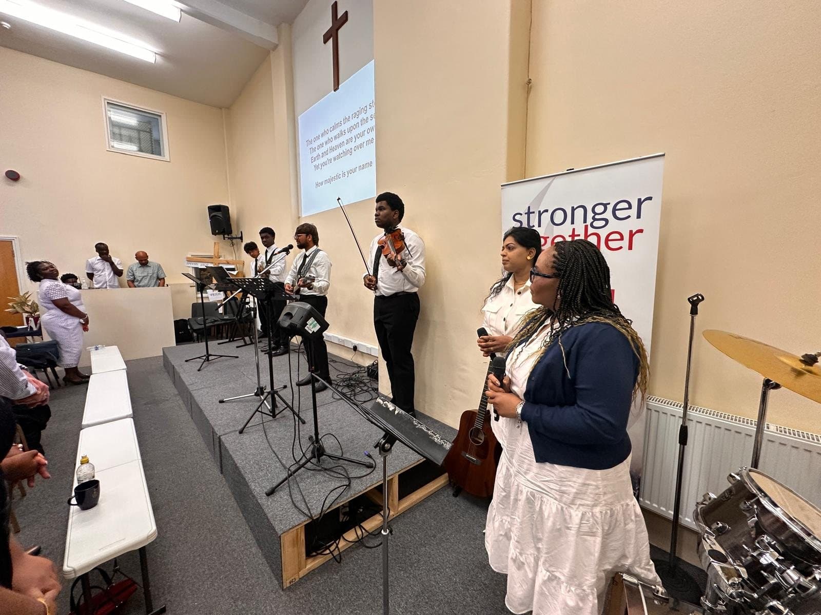 Young musicians and singers leading praise and worship from the stage on a Sunday morning
